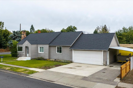 Gray house with attached garage and carport in this luxury house for sale in Redmond ($419,900 - 132 m²)