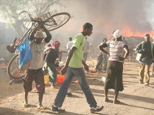 Residents of KCC village in Naivasha salvage their property after a fire gutted down their houses leaving at least 3,000 of them homeless in this file picture of June 2012.//George Murage