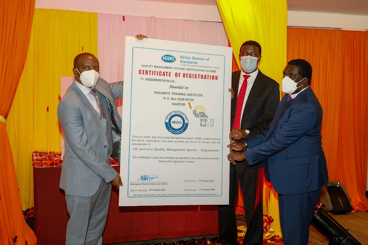 Kenya Bureau of Standards MD John Njiraini, Treasury CAS Nelson Gaichuhie and Kenya Railways board Chairman Pastor Awitta receives ISO certification at Sarova Panafric Hotel on Monday June 21, 2021