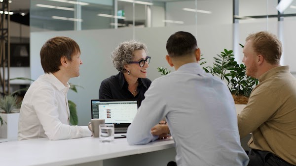 Cluey team members meeting at a desk