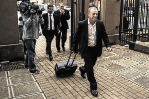 READY: Gerrie Nel arrives at the Pretoria high court to hear Judge Thokozile Masipa's ruling on the state's appeal of Oscar Pistorius's conviction and sentencing for for killing Reeva Steenkamp PHOTO: GIANLUIGI GUERCIA/AFP