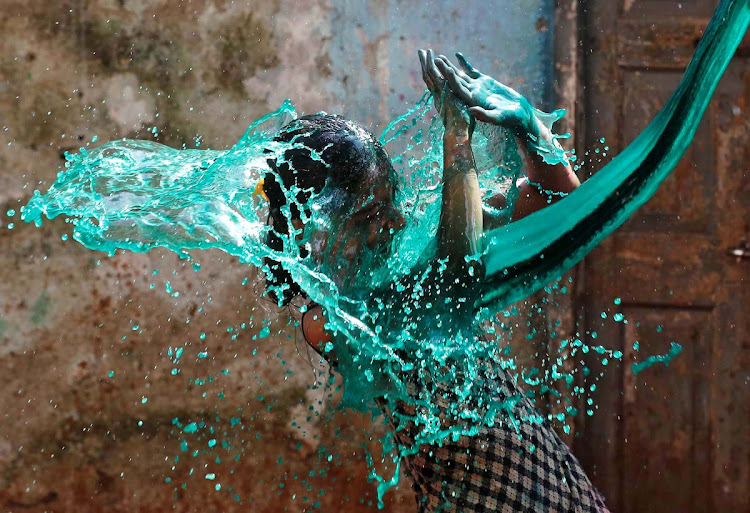 A girl reacts as coloured water is thrown on her face while celebrating Holi, the Festival of Colours, in Mumbai, India, March 13, 2017.