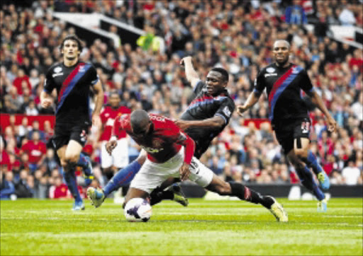 TUMBLING: Manchester United's Ashley Young is 'fouled' by Crystal Palace's Kagisho Dikgacoi during their English Premier League soccer match at Old Trafford on Saturday. Man United won 2-0 PHOTO: REUTERS