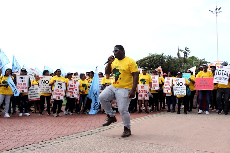 A leader of the march demonstrating outside Suncoast Casino calling for the protection of beaches.