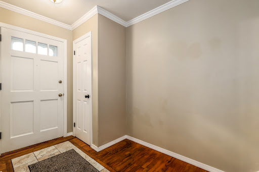 Entrance with white door and wood floor - Luxury house for sale in Bethel, 3 bedrooms
