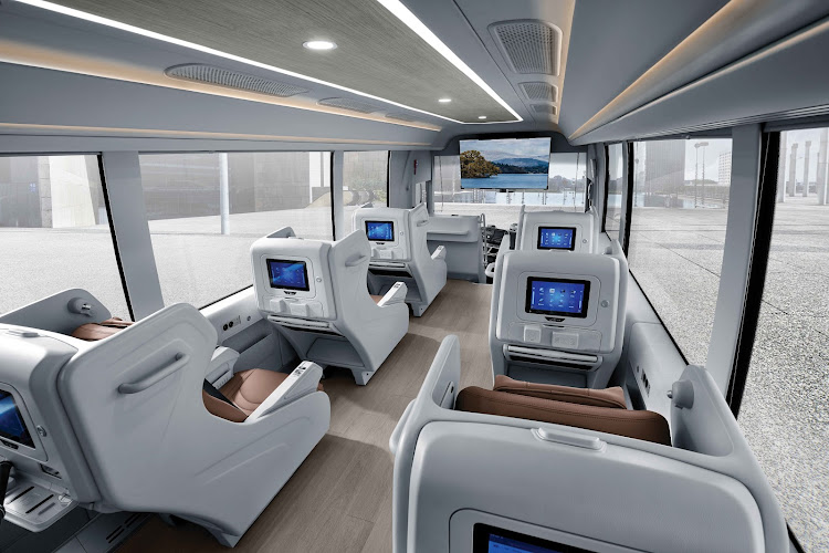 A section of the Mobile Office features single, business class seats with monitors.