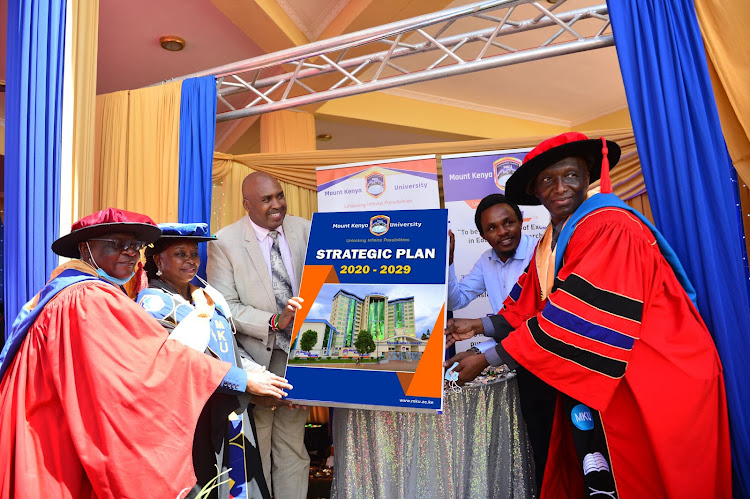 Mount Kenya University council chairman David Serem, Dr Jane Nyutu, chairman and founder Simon Gicharu, Education CAS Zack Kinuthia and vice-chancellor Deogratius Jaganyi display 2020-29 strategic plan after its launch on its main campus in Thika on February 3, 2021.