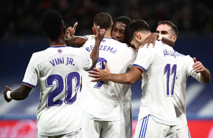 Real Madrid's Karim Benzema celebrates with teammates after scoring against Rayo Vallecano