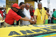 SACP general secretary Blade Nzimande, then deputy president Kgalema Motlanthe, President Jacob Zuma, Cosatu president S'dumo Dlamini and former ANC treasurer-general Mathews Phosa share a jovial moment at the ANC's 98th anniversary celebrations in Kimberley 2010.