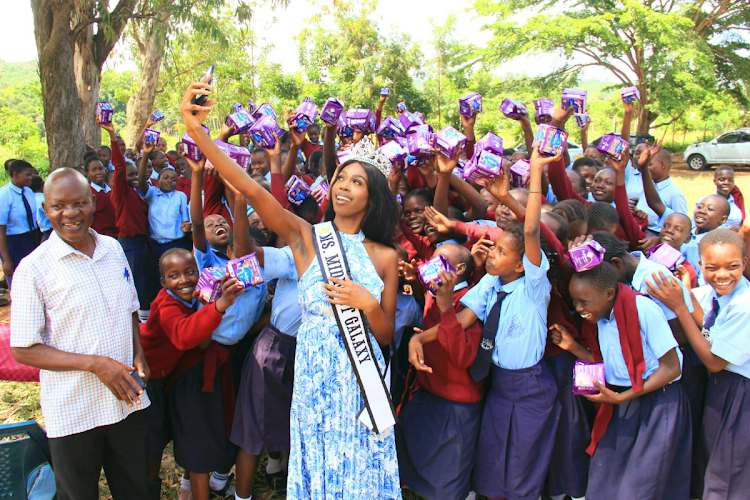 Ms Midwest Galaxy 2024, Keerah Yeowang takes selfies with pupils at Kodiaga Prison Primary School where she donated sanitary pads on March 29, 2024.