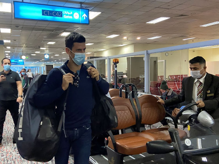 Serbian tennis player Novak Djokovic walks at Dubai Airport after the Australian Federal Court upheld a government decision to cancel his visa to play in the Australian Open on January 17 2022. REUTERS/ABDEL HADI RAMAHI