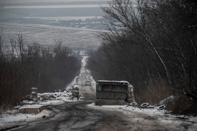 A car rides on an empty road near the front line in Donetsk region, Ukraine, January 29 2023. Picture: VIACHESLAV RATYNSKYI/REUTERS