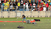 A fan vandalises broadcasters' equipment during a match between Kaizer Chiefs and Free State Stars at Moses Mabhida Stadium in Durban in April. 