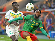 Georges Kevin Nkoudou Mbida of Cameroon is challenged by Krepin Diatta of Senegal during their Africa Cup of Nations clash at Charles Konan Banny Stadium in Yamoussoukro.