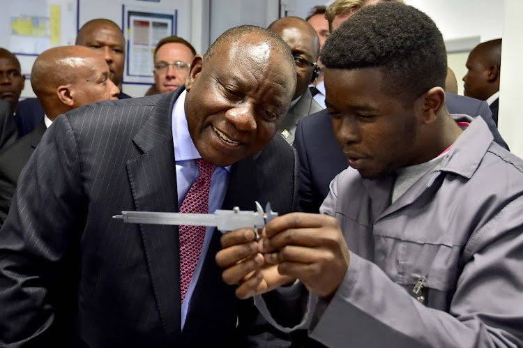 President Cyril Ramaphosa gets a crash course in building cars from Lukhanyo Ncapayi of the Mercedes-Benz Learning Academy in East London. Ramaphosa was there to announce that Mercedes-Benz is to invest a further €600-million into South Africa.