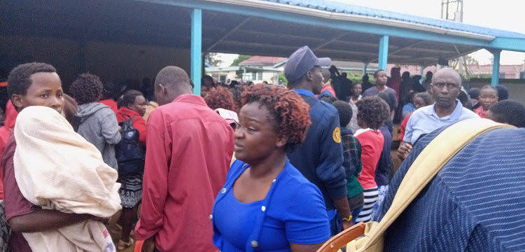 Parents outside the emergency department at the Kakamega County Referral Hospital