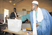 CHANGING TIMES: A   man votes in Dakar during Senegal's election at the weekend. President Abdoulaye Wade admits he could face  a runoff on Sunday, having defied  warnings that his candidacy risks destabilising the historically tranquil country. photo: REUTERS