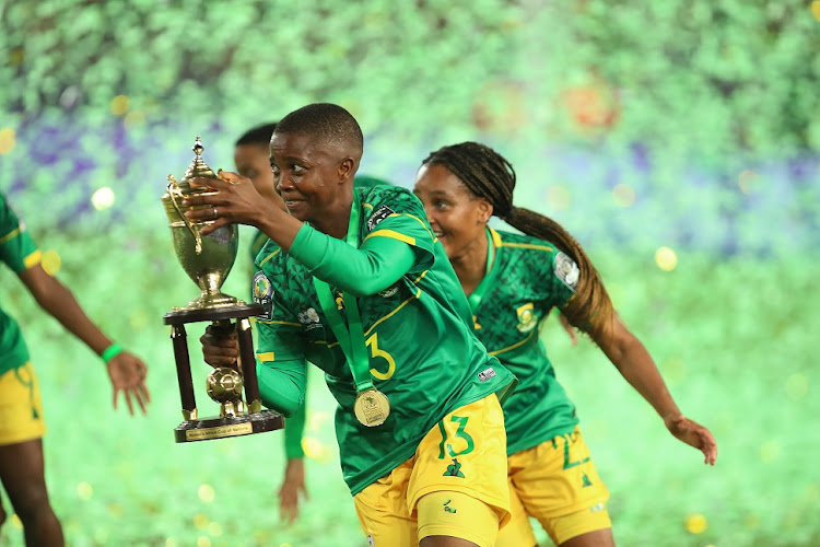 Bambanani Mbane celebrates with the trophy.