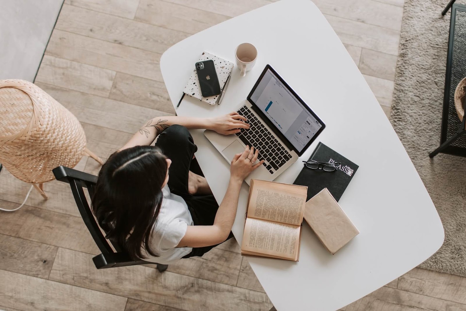 Woman looking through books at a desk