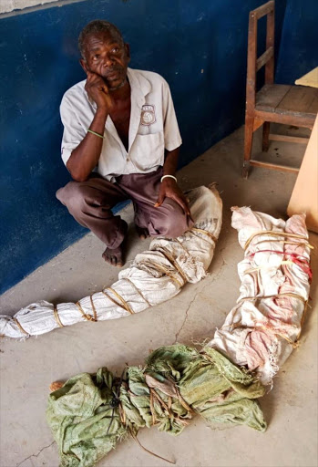 Changawa Kaisha with the elephant tasks concealed in sacks at Mariakani police station on Tuesday. /COURTESY