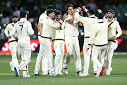  Pat Cummins of Australia celebrates with his team after taking the wicket of Prithvi Shaw of India during day two of the First Test match between Australia and India at Adelaide Oval on December 18, 2020 in Adelaide, Australia. 