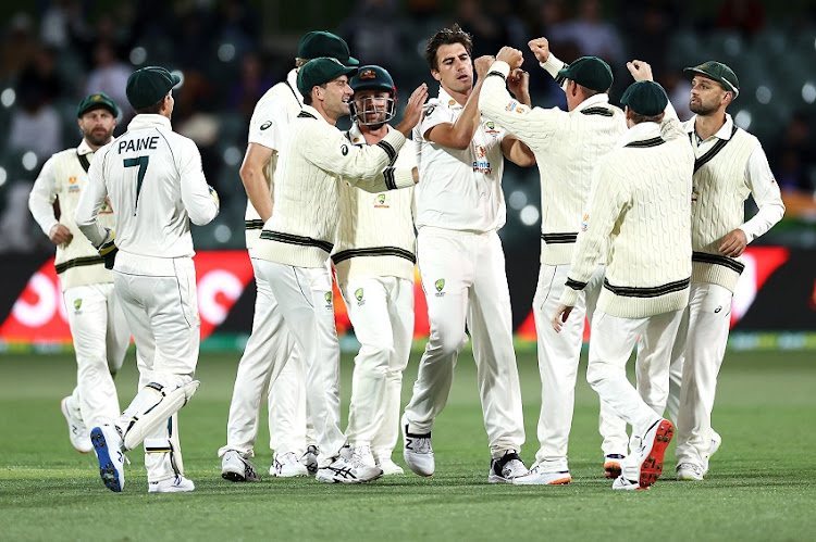 Pat Cummins of Australia celebrates with his team after taking the wicket of Prithvi Shaw of India during day two of the First Test match between Australia and India at Adelaide Oval on December 18, 2020 in Adelaide, Australia.