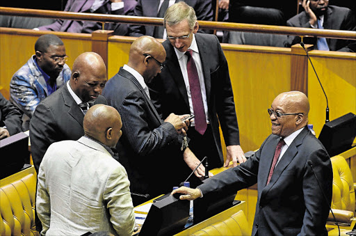 LIGHTER MOMENT: President Zuma chats shares a light moment with ANC MPs before the start of the final question and answer session for 2016 in parliament yesterday