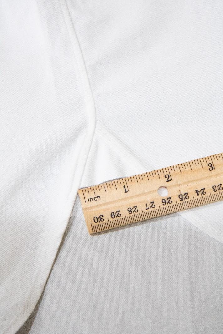 A ruler on a white fabric

Description automatically generated