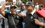 WE WON   An elated Lawrence Dube, right,  leaves the Pietermaritzburg High Court  following the outcome of the court case on Tuesday  Picture: Khaya Ngwenya