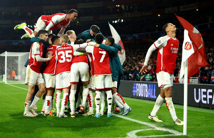 Arsenal players celebrate after the Champions League round of 16, second leg victory over Porto at Emirates Stadium, London on March 12, 2024