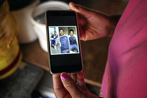 Nolwazi Mjoli holds out a picture of her son Siyanda at her home in Daveyton, Ekurhuleni.