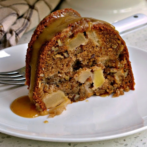 A scrumptiously moist Apple Cake with chunks of fresh apples and pecans all topped with an easy four ingredient caramel drizzle.