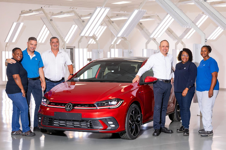 From left, Luleka Bastile (quality assurance), Carsten Berger (head quality assurance), Juergen Manthey (quality assurance), Ulrich Schwabe (production director), Pumza Mboniswa (production) and Ntombizandile Gamanda (production) with the 1.5-millionth vehicle built for export in Kariega.