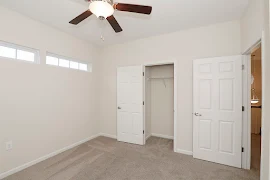 Corner of bedroom facing opposite wall with closet and bedroom door leading to the hallway on the right