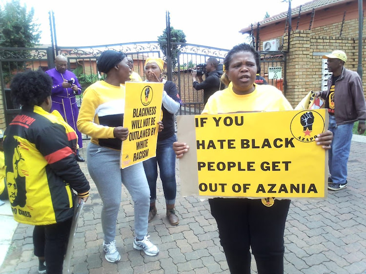 Members of the Azanian People's Organisation (Azapo) picket outside Belinda Magor's residence.