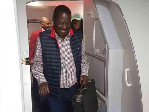 Opposition leader Raila Odinga alights from a Kenya Airways plane at the JKIA on November 17, 2017. /COURTESY