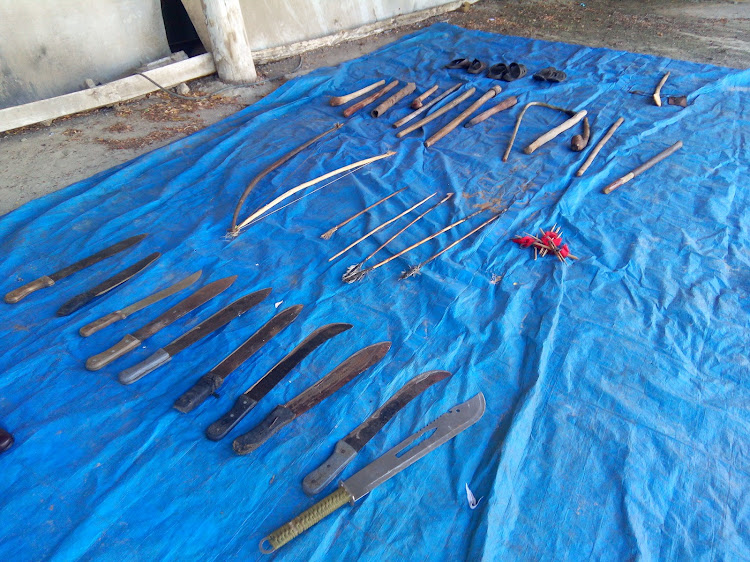 Some of the weapons recovered from the camp spread out at Mariakani Police Station on Saturday