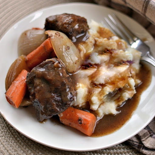 Beef Short Ribs Recipe slow cooks perfectly seasoned beef short ribs, carrots and onions.