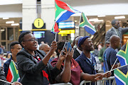 Fans welcome the award-winning musicians at OR Tambo International Airport.