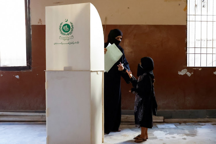 A woman voter speaks with her daughter as she is about to cast a vote during the general election in Karachi, Pakistan, on February 8, 2024. Picture: REUTERS/Akhtar Soomro