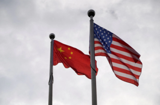 Chinese and U.S. flags flutter outside a company building in Shanghai, China November 16, 2021.