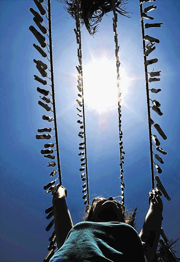 A Greenpeace volunteer installs wind chimes on Durban's North beach, where the COP17 event is taking place Picture: GREENPEACE