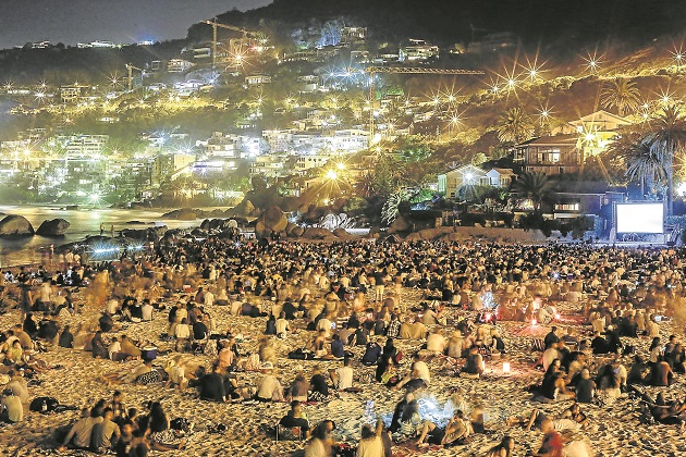 Evening visitors to Clifton's Fourth Beach during the Wavescape film festival. Beachgoers are annoyed by the activities of a security company on the beach and have called for mass demonstrations.