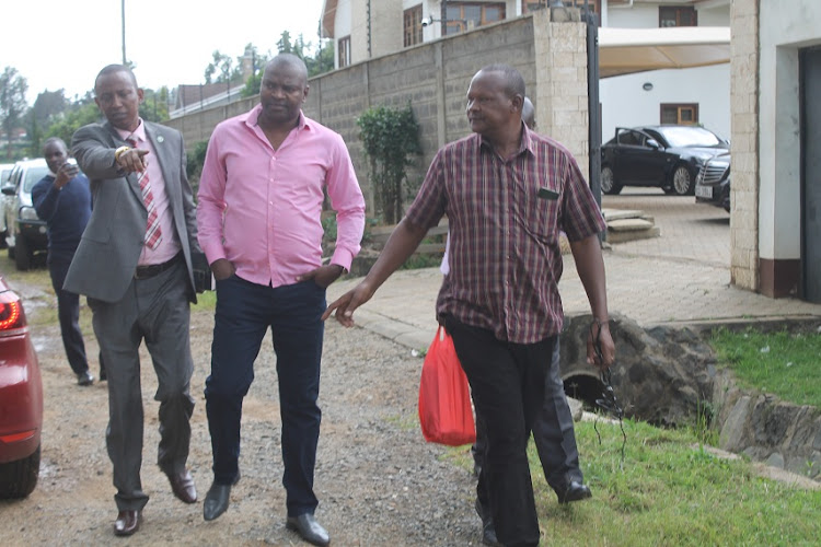 Former Sports CS Rashid Esecha (C) is led by detectives out of his Karen home in Nairobi on Monday, March 2, 2020.