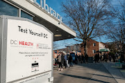 People receive free Covid-19 self testing kits being distributed to the public by the government at the Anacostia public library in Washington, US on December 23 2021. 
 