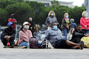 People watch the funeral service of Archbishop Desmond Tutu on a big screen in Cape Town, South Africa, January 1, 2022. 