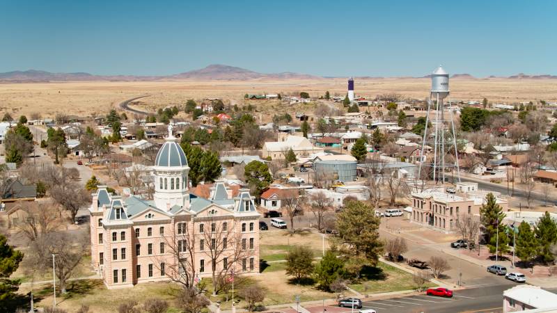 Aerial view of Marfa, a small town in West Texas, with mountains in the background.