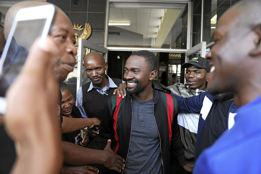 Mpumalanga businessman Sam Chabalala is mobbed by well-wishers after he was granted bail of R200,000 in the Witbank magistrate's court on Monday. /Thulani Mbele