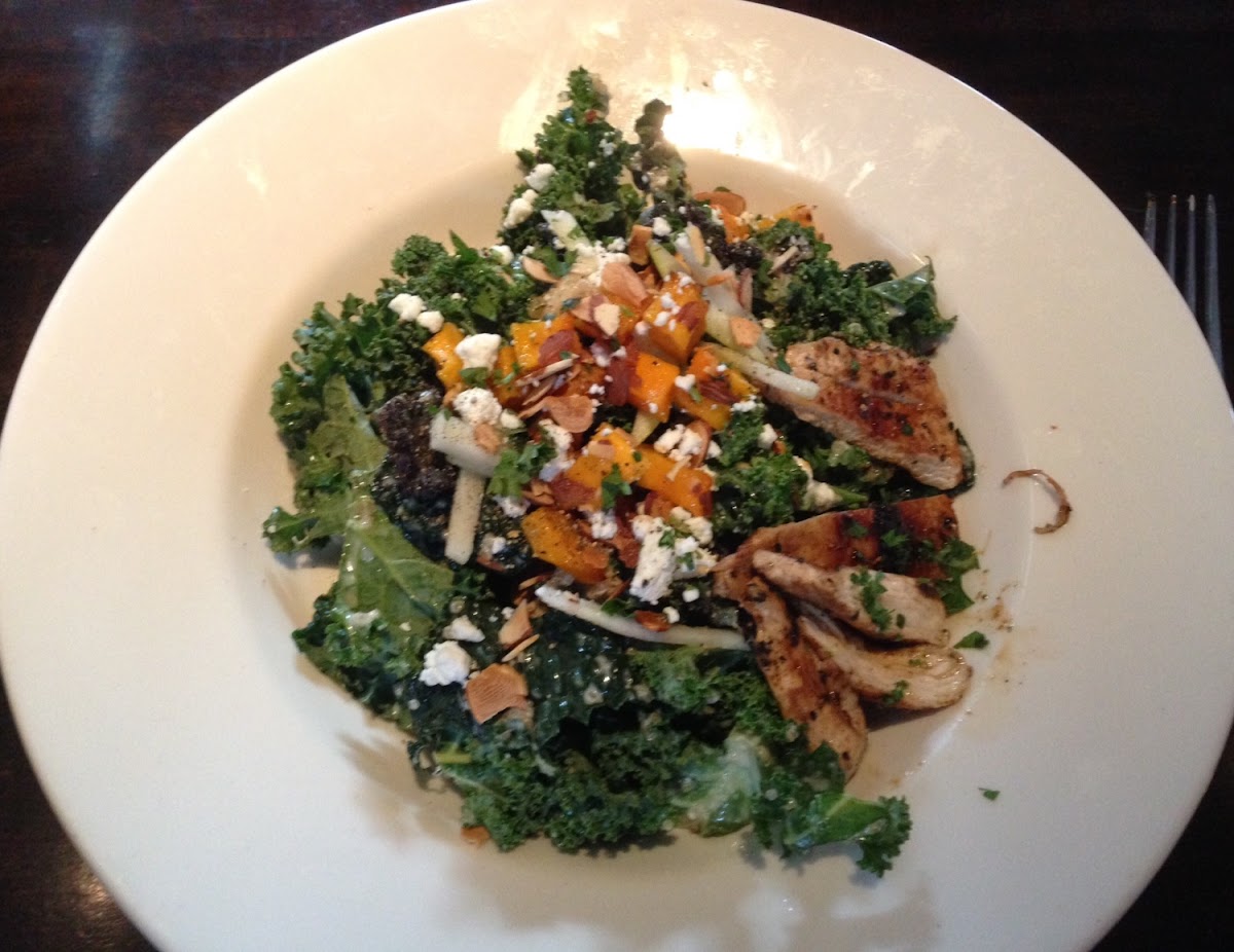 Butternut squash, goat cheese, almonds, quinoa and kale salad with chicken. 
I think it had Apple-miso dressing.