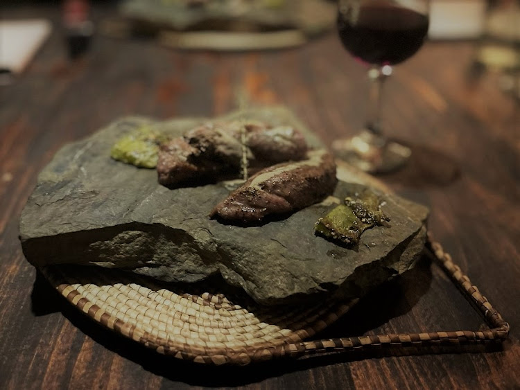 Ostrich fillet with roasted prickly pear served on a hot stone from the nearby riverbed